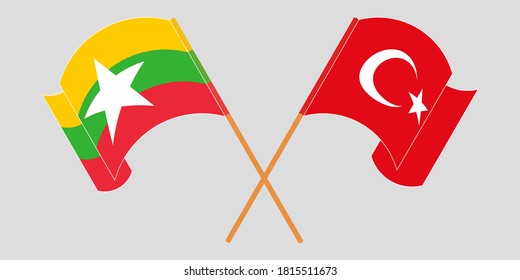 Crossed and waving flags of Myanmar and Turkey