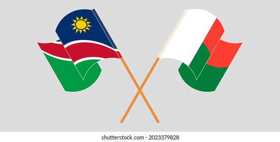 Banderas cruzadas y ondeando banderas de Namibia y Madagascar