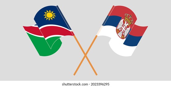Crossed and waving flags of Namibia and Serbia