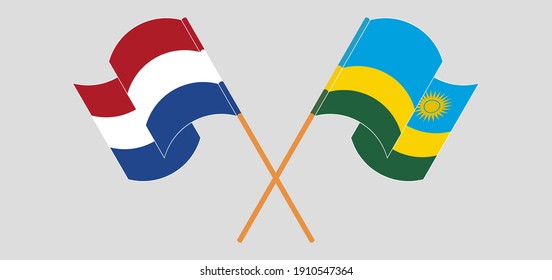 Banderas cruzadas y ondeando banderas de los Países Bajos y Ruanda