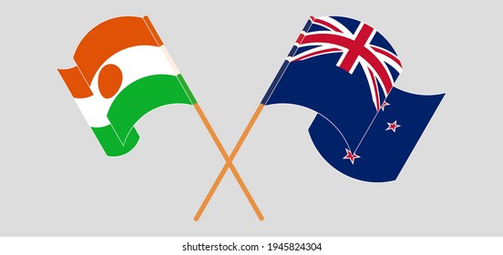 Crossed and waving flags of Niger and New Zealand