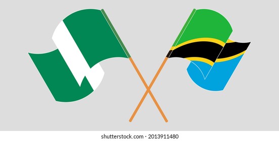 Crossed and waving flags of Nigeria and Tanzania