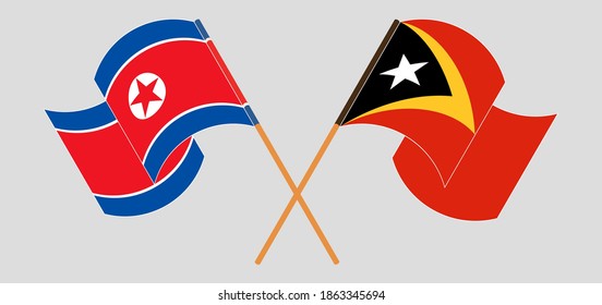 Crossed and waving flags of North Korea and East Timor