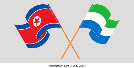 Crossed and waving flags of North Korea and Sierra Leone