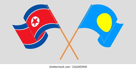 Crossed and waving flags of North Korea and Palau. Vector illustration
