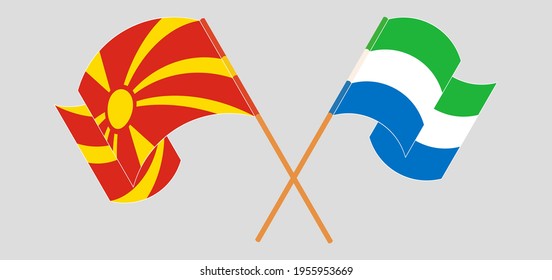 Crossed and waving flags of North Macedonia and Sierra Leone