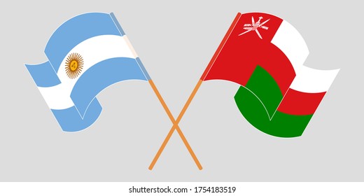 Crossed and waving flags of Oman and Argentina