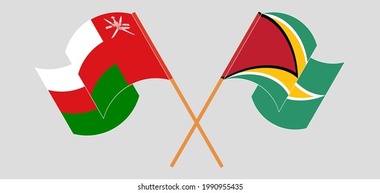 Crossed and waving flags of Oman and Guyana