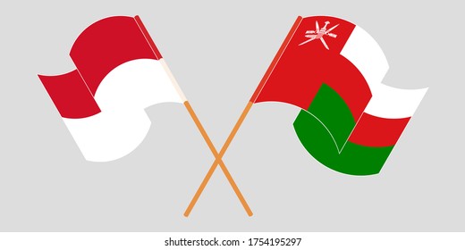 Crossed and waving flags of Oman and Indonesia