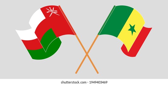 Crossed and waving flags of Oman and Senegal