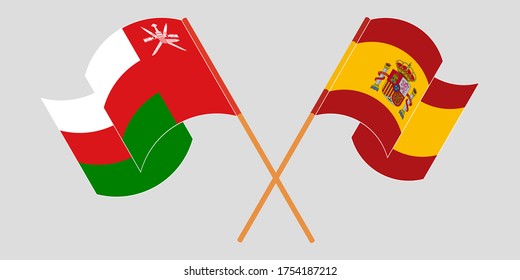 Crossed and waving flags of Oman and Spain