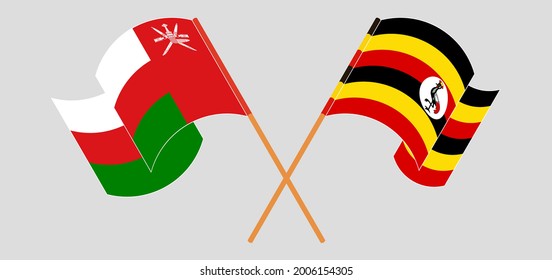 Crossed and waving flags of Oman and Uganda