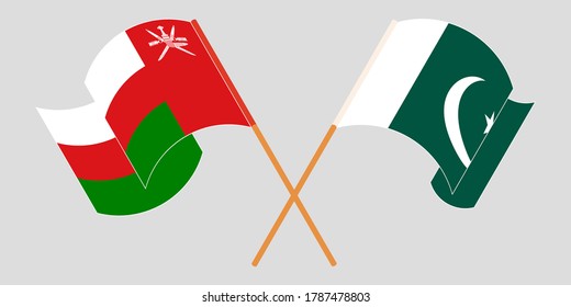 Crossed and waving flags of Pakistan and Oman