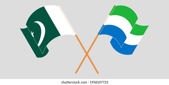 Crossed and waving flags of Pakistan and Sierra Leone