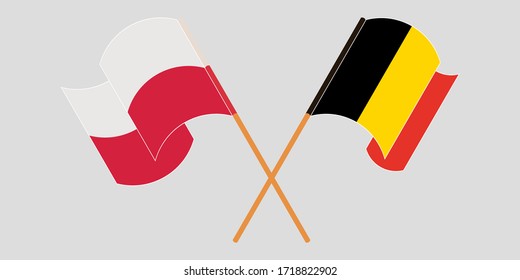 Crossed and waving flags of Poland and Belgium