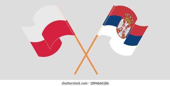 Crossed and waving flags of Poland and Serbia