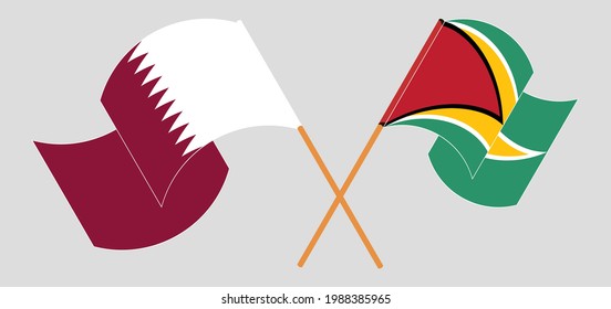 Crossed and waving flags of Qatar and Guyana