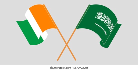 Crossed and waving flags of Republic of Ivory Coast and the Kingdom of Saudi Arabia