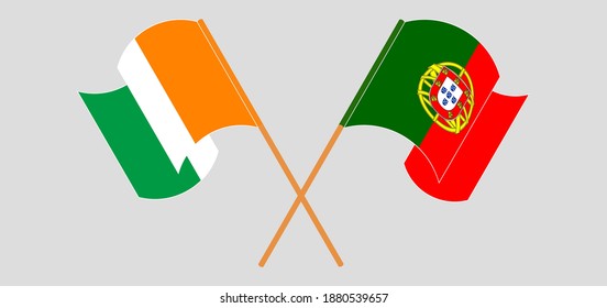 Crossed and waving flags of Republic of Ivory Coast and Portugal