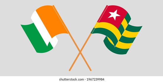 Crossed and waving flags of Republic of Ivory Coast and Togo