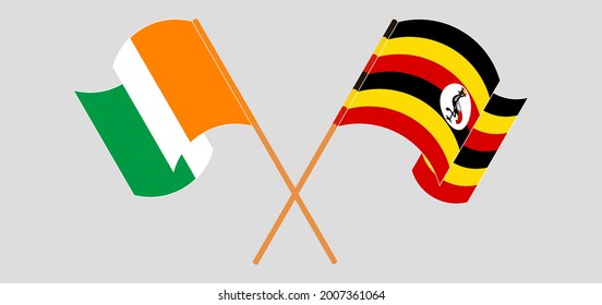 Crossed and waving flags of Republic of Ivory Coast and Uganda