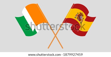 Crossed and waving flags of Republic of Ivory Coast and Spain