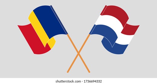 Crossed and waving flags of Romania and the Netherlands
