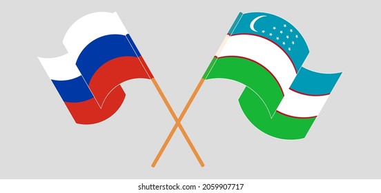 Crossed and waving flags of Russia and Uzbekistan
