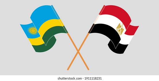Banderas cruzadas y ondeando banderas de Ruanda y Egipto