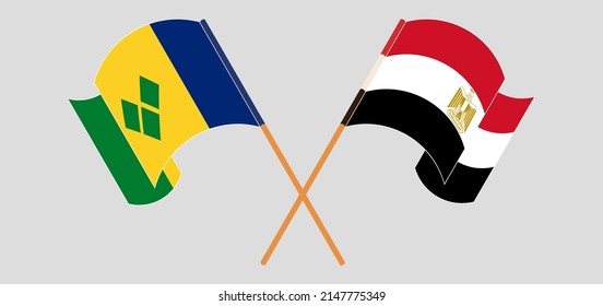 Crossed and waving flags of Saint Vincent and the Grenadines and Egypt. Vector illustration
