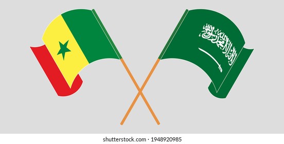 Crossed and waving flags of Senegal and the Kingdom of Saudi Arabia