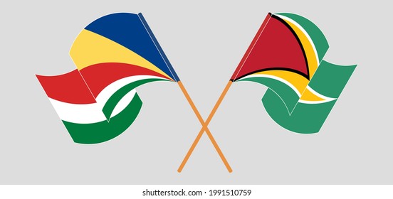 Crossed and waving flags of Seychelles and Guyana