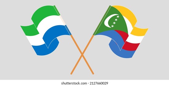 Crossed and waving flags of Sierra Leone and Comoros. Vector illustration
