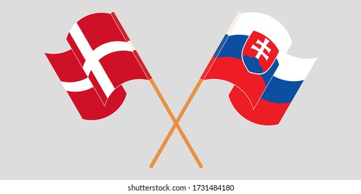 Crossed and waving flags of Slovakia and Denmark