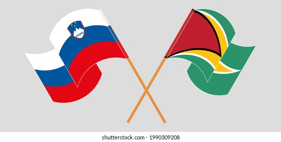 Crossed and waving flags of Slovenia and Guyana