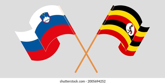 Überquerte und wehende Flaggen Sloweniens und Ugandas