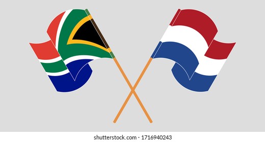 Crossed and waving flags of South Africa and the Netherlands
