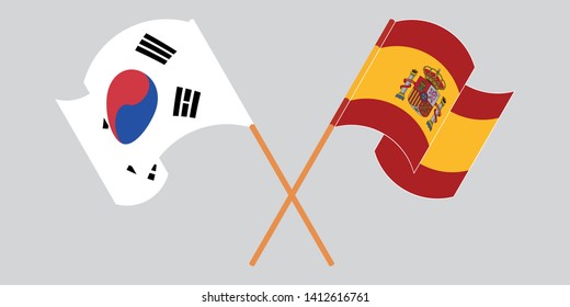 Crossed and waving flags of South Korea and Spain