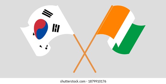 Crossed and waving flags of South Korea and Republic of Ivory Coast