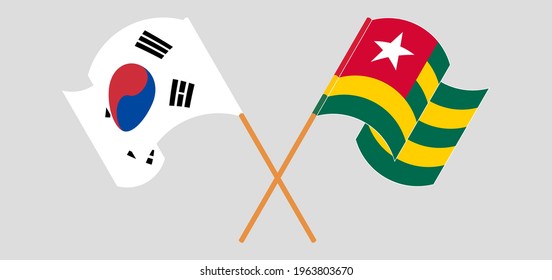 Crossed and waving flags of South Korea and Togo