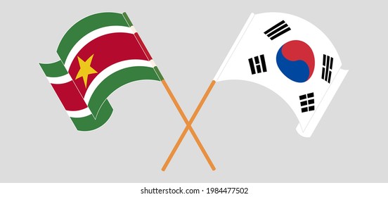 Crossed and waving flags of South Korea and Suriname