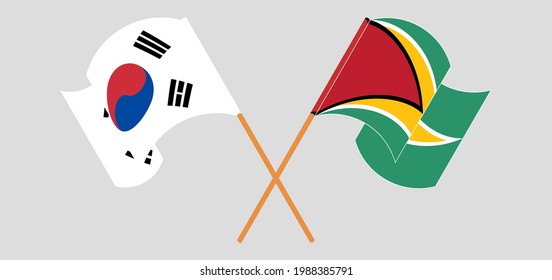 Crossed and waving flags of South Korea and Guyana