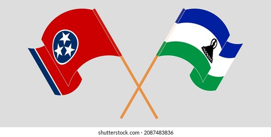 Crossed and waving flags of The State of Tennessee and Kingdom of Lesotho. Vector illustration
