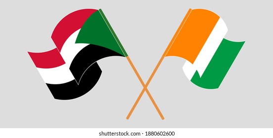 Crossed and waving flags of the Sudan and Republic of Ivory Coast