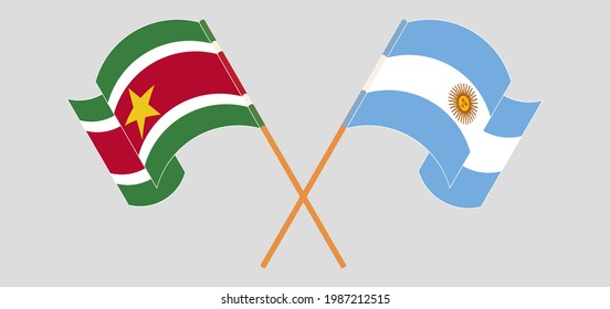 Crossed and waving flags of Suriname and Argentina