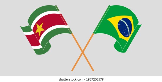 Crossed and waving flags of Suriname and Brazil