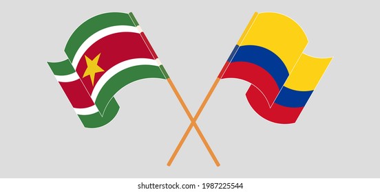 Crossed and waving flags of Suriname and Colombia