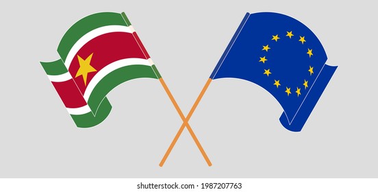 Crossed and waving flags of Suriname and the European Union