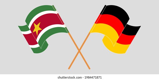 Crossed and waving flags of Suriname and Germany