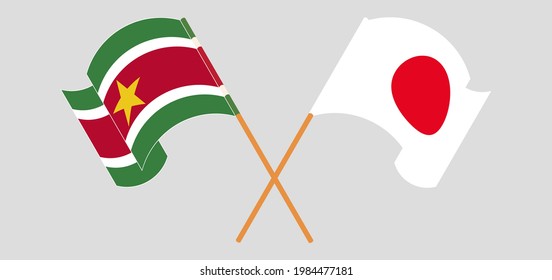 Crossed and waving flags of Suriname and Japan